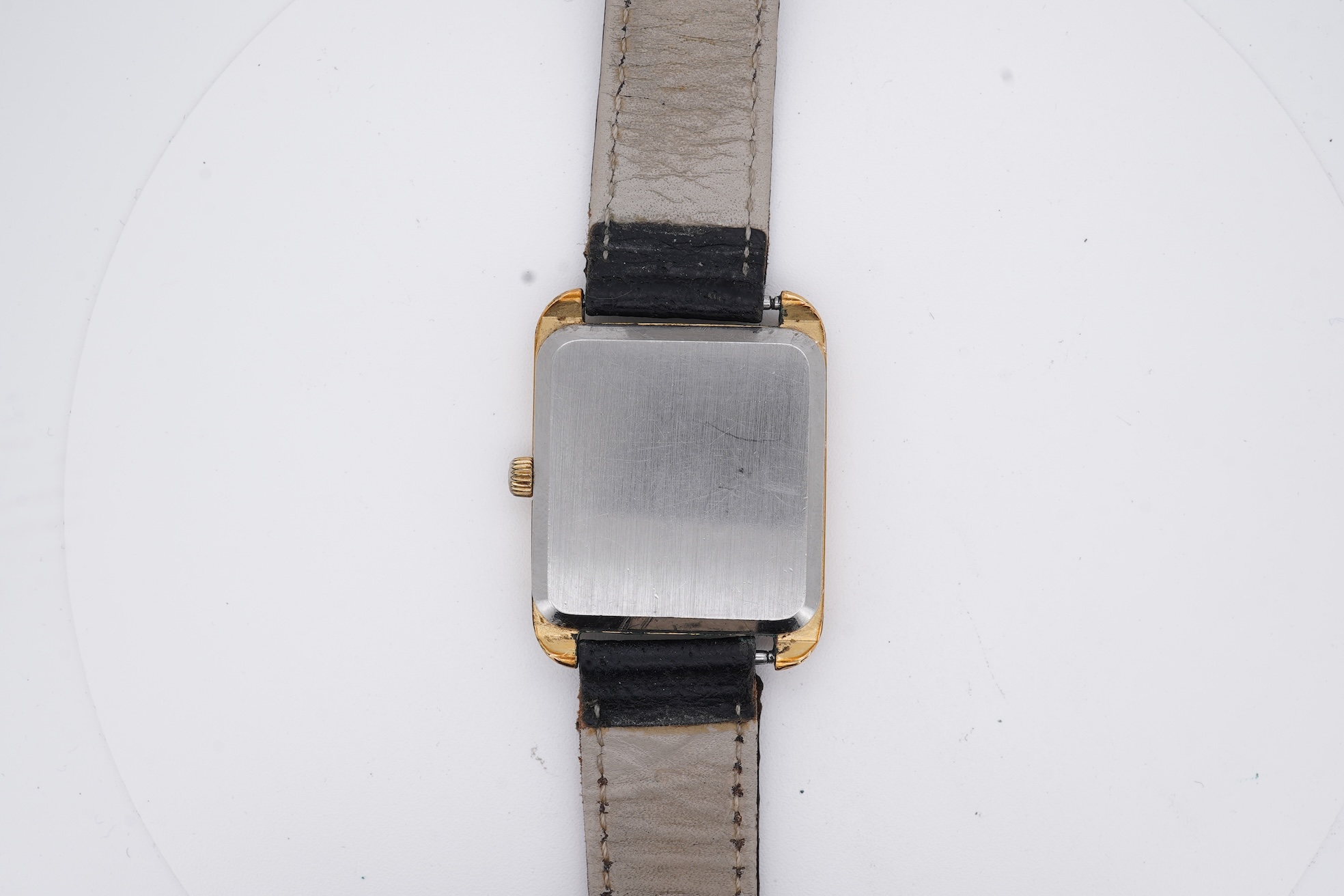 A gentleman's late 1970's steel and gold plated Omega De Ville quartz wrist watch, with rectangular dial and baton numerals, movement c.1330, case diameter 30mm, no buckle, box or papers.